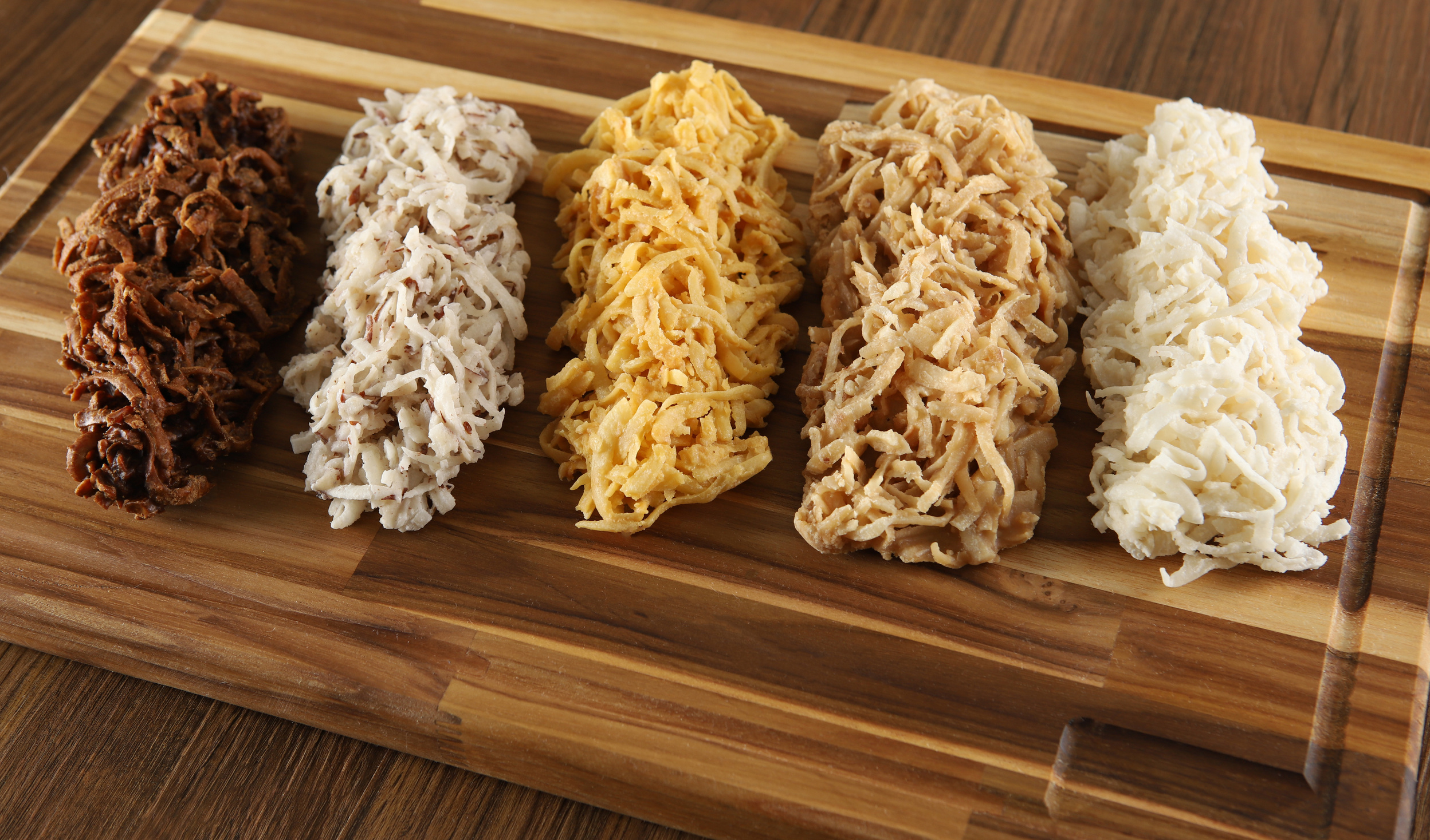 Cocada, coconut candy. Composition on wooden background.