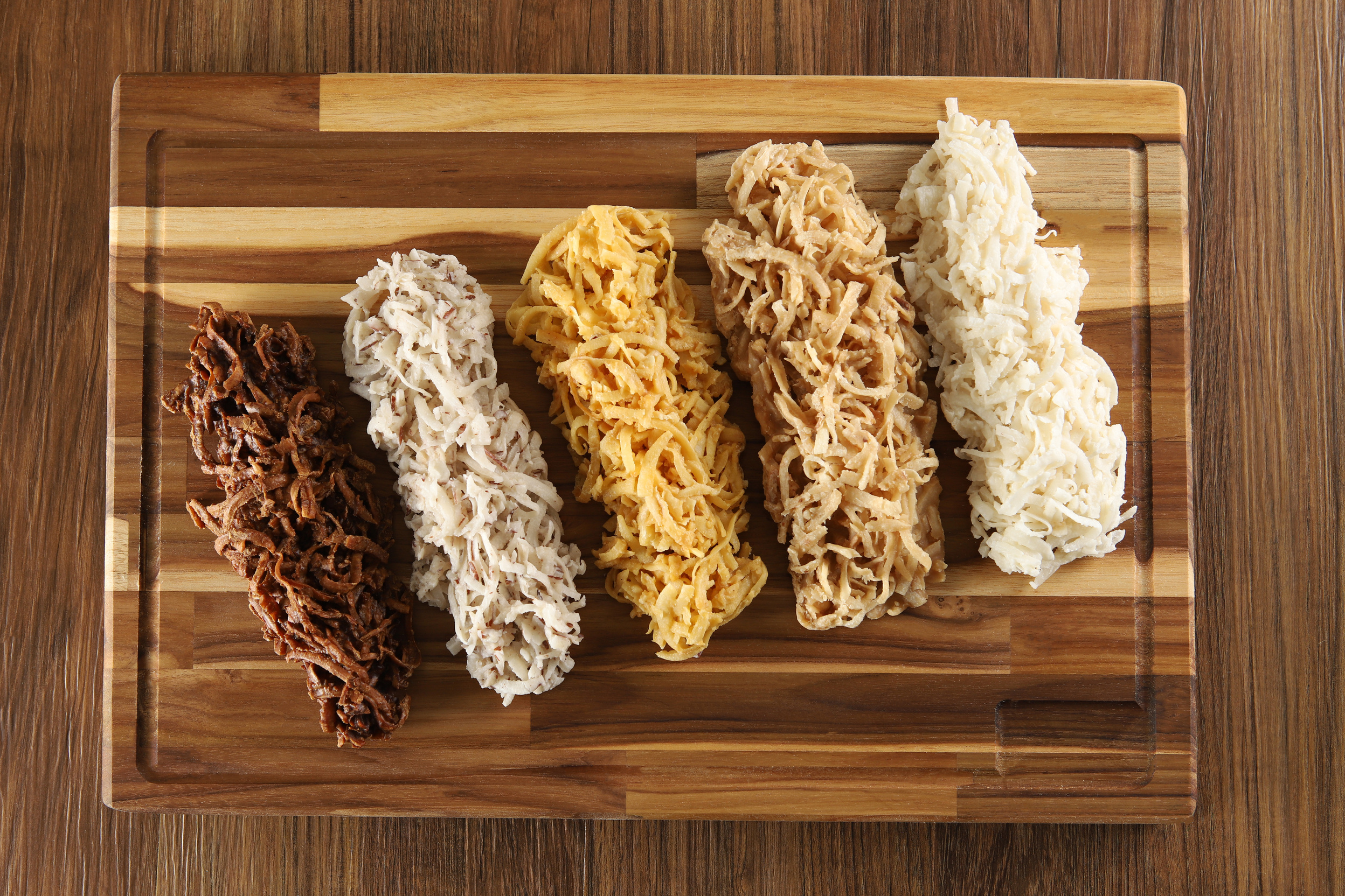 Cocada, coconut candy. Composition on wooden background.