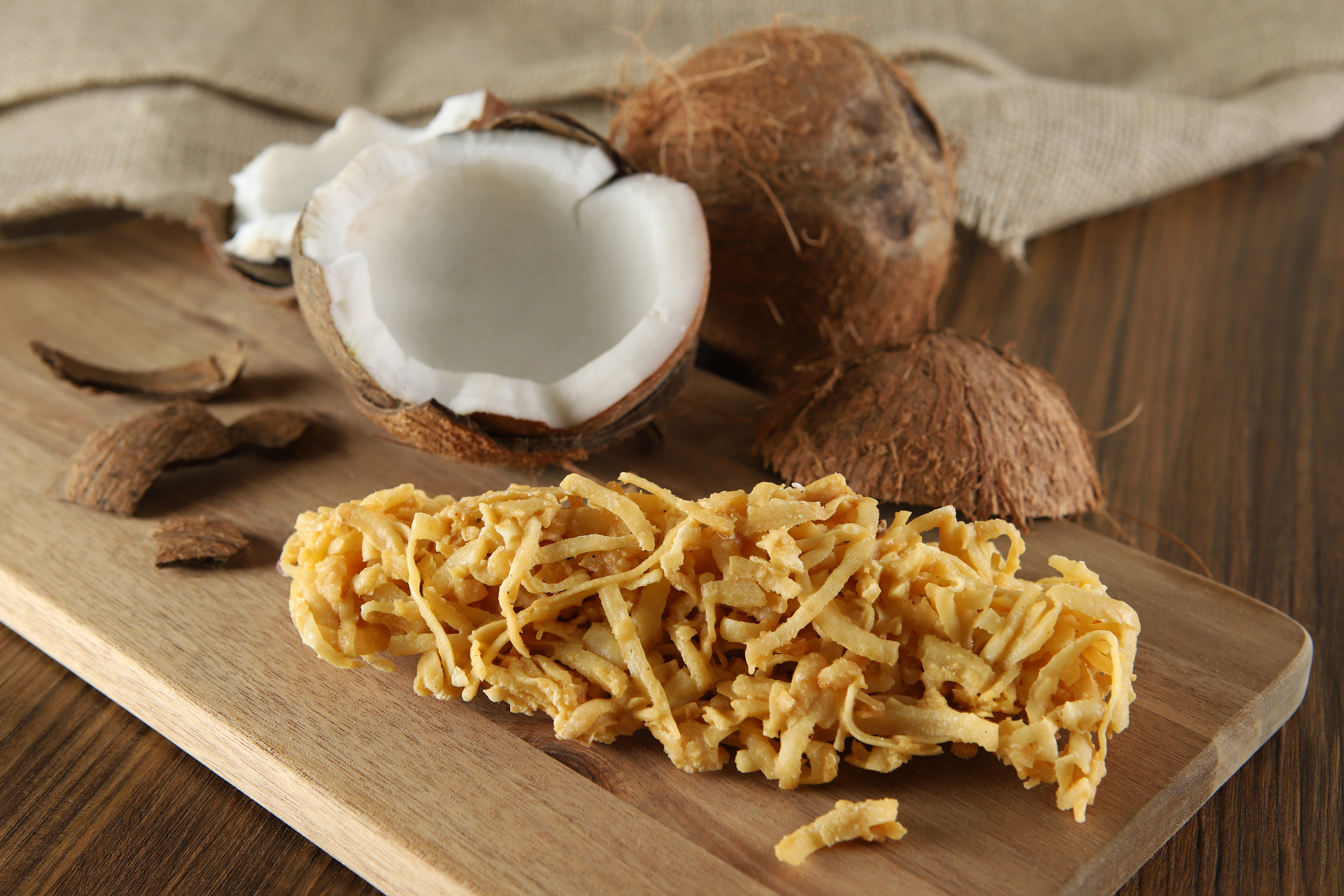 Cocada, coconut candy. Composition on wooden background.