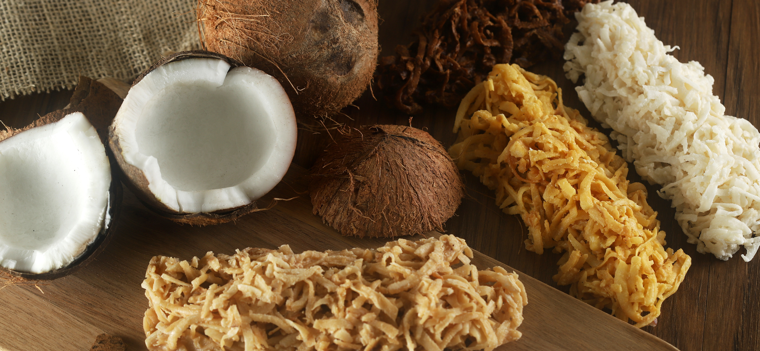 Cocada, coconut candy. Composition on wooden background.